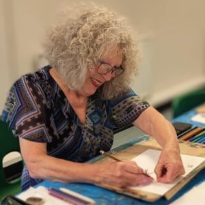 Smiling Basingstoke student drawing