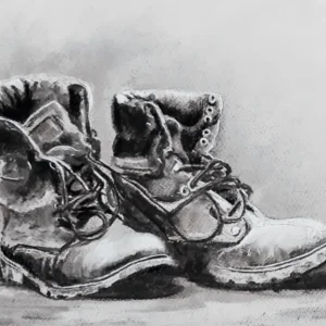Artwork of a pair of boots created in charcoal.