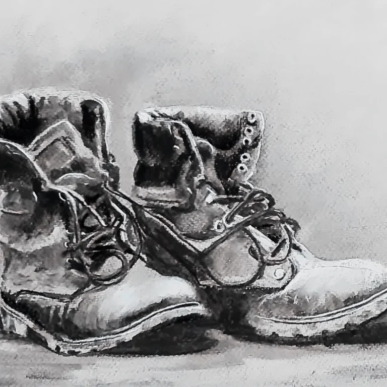 Artwork of a pair of boots created in charcoal.
