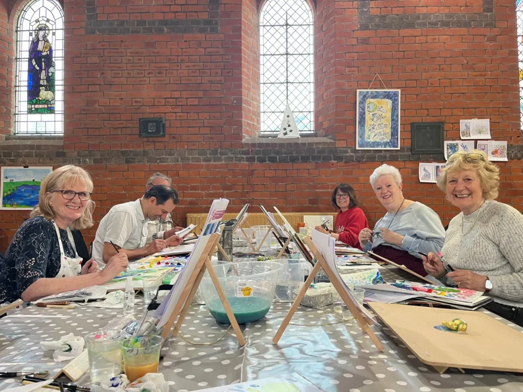 Happy art students working on their paintings at one of our art classes